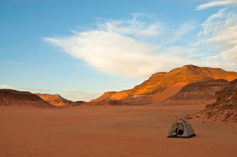 Night camp in Great Sand Sea desert, A Tend protect gears during sand storms